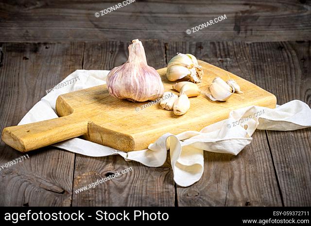 Vintage still life with garlic on wooden table