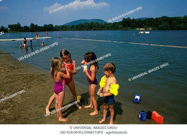 Four Children On The Beach, Boys And Girls, Flotation Arm Bands