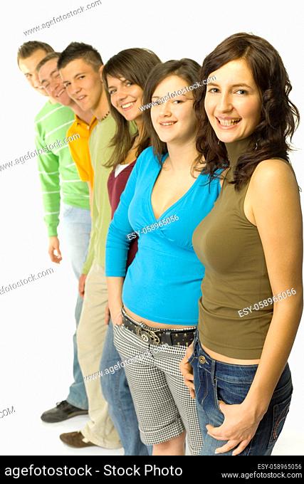 Group of 6 teenagers standing in line. They're looking at camera and smiling
