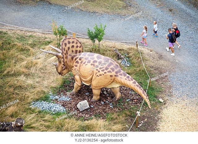 Triceratops from top. Family passing by. Looking down from tower Stüppel. Adventure Park Fort Fun in the Sauerland (Hochsauerland) near Bestwig-Wasserfall