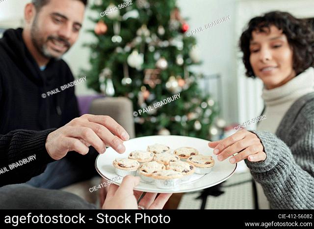 Couple enjoying Christmas mince pies