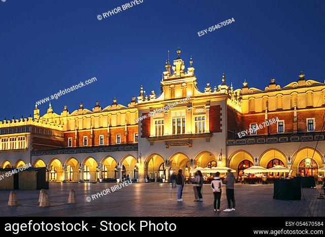 Krakow, Poland. Evening Night View Of Cloth Hall Building Of The Main Market Square. Famous Historical Landmark And UNESCO World Heritage Site