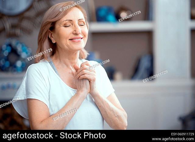 Happy Woman Is Pressing Her Arms To The Chest. Satisfied Woman With Closed Eyes Smiles And Presses Hands To The Chest. Portrait. Woman In Prayer Pose
