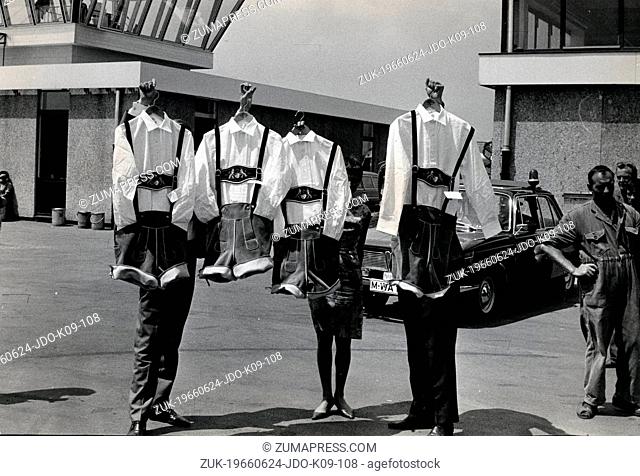 June 24, 1966 - Munich, Germany - One of the most successful and popular musical groups throughout history, The BEATLES, hold up their outfits for a concert in...
