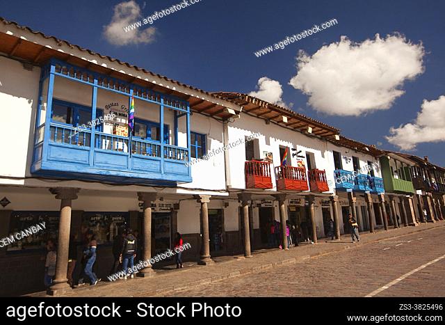 View to the colonial buildings with balconies used as cafe-restaurant in Plaza De Armas at the historic center, Cusco, Peru, South America