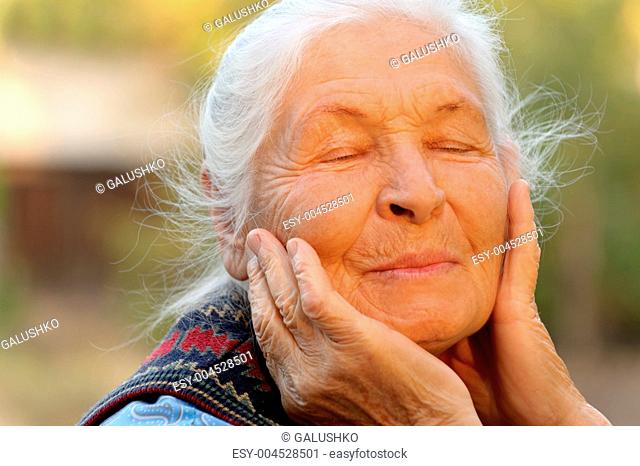 The elderly woman with closed eyes