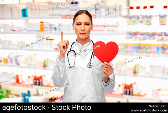 female doctor with heart pointing finger up