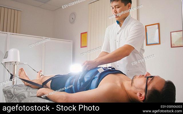 Osteopathic doctor perform procedure, stretching the spine, chiropractic, Asian Tibetan medicine, close up
