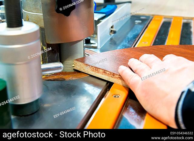 Close-up Carpenter works for Edge Banding Machine In workshop