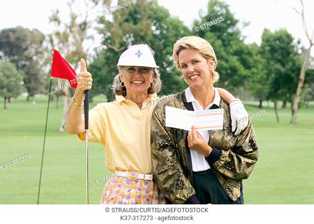 Golfing women showing their score cards