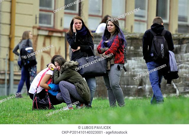 Students reacts near their high school where a woman stabbed and killed a teenager and injured two other students in Zdar nad Sazavou