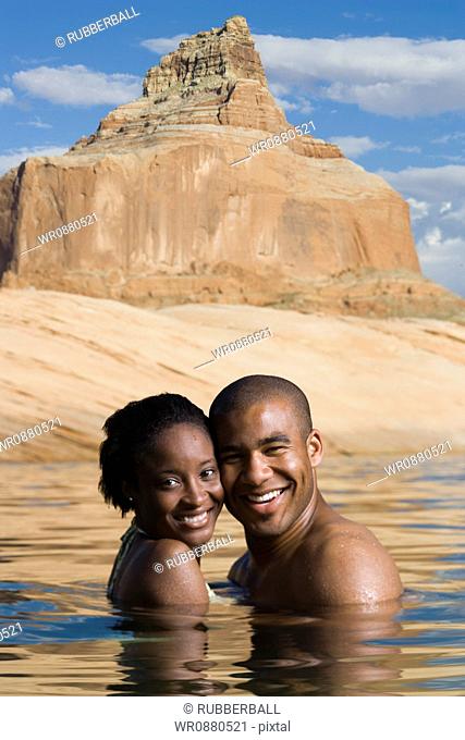 Portrait of a young couple standing in a lake