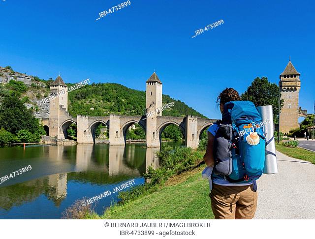 Cahors.Pilgrim on Pont Valentre, Santiago de Compostela pilgrimage road, River Lot, Departement Lot, Occitanie, France