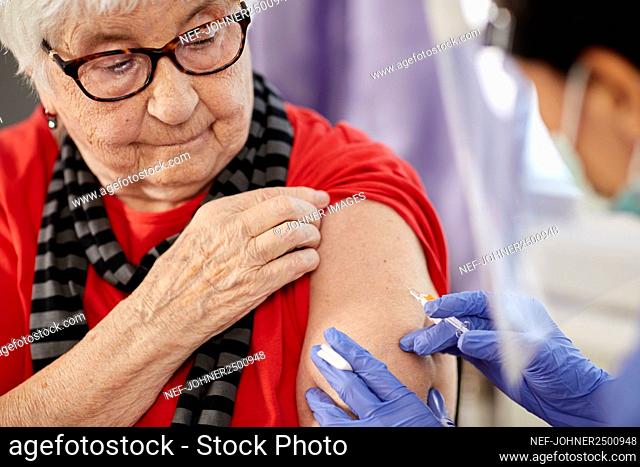 Senior woman getting covid vaccine