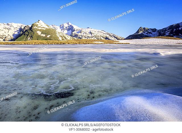 Ice melting at Lake Andossi during thaw, Chiavenna Valley, Spluga Valley, Sondrio province, Valtellina, Lombardy, Italy