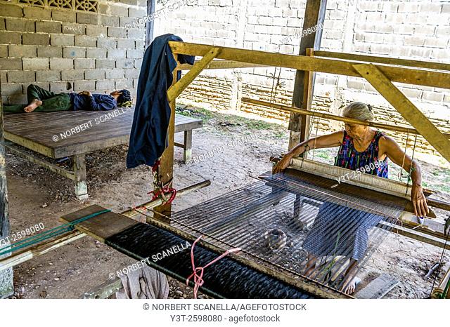 Asia. South-East Asia. Laos. Province of Champassak. Pakse. Village weaver. Woman working at weaving