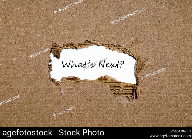 The words what's next appearing behind torn paper