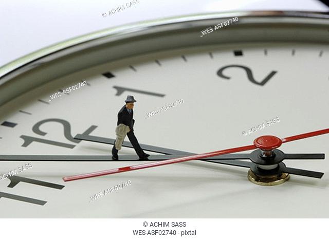 Clock with figurine on pointer, close-up