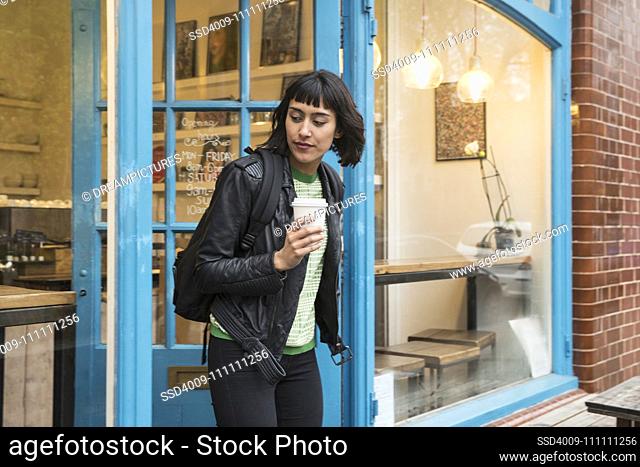 Woman walking out of cafe