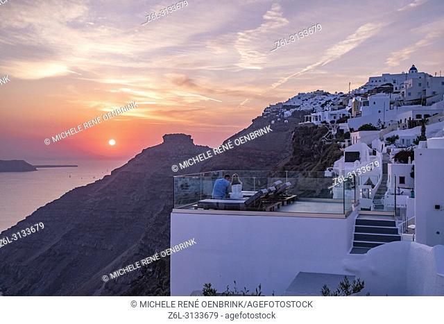 Scenic overlook at sunset of the volcanic caldera at the town of Fira, Cyclades islands, Agean Sea, at the Santorini Greece