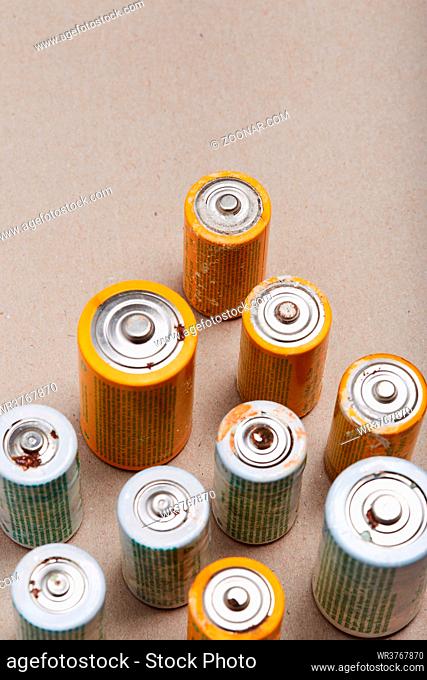 Discharged batteries on paper background. Collecting used batteries to recycle. Waste disposal and recycling. Copy space for text