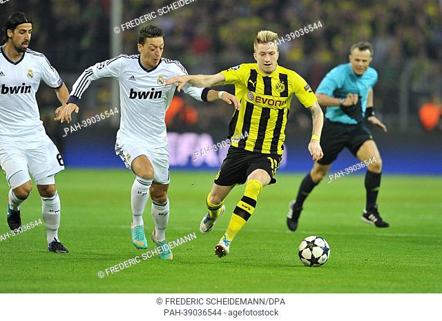 Dortmund's Marco Reus (R) vies for the ball with Madrid's Mesmut Oezil (L) during the UEFA Champions League semi-final first leg soccer match between Borussia...