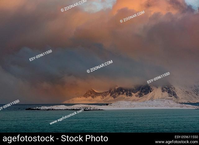 Winter Norway. Deserted mountainous coast of the ocean. The weather is getting worse