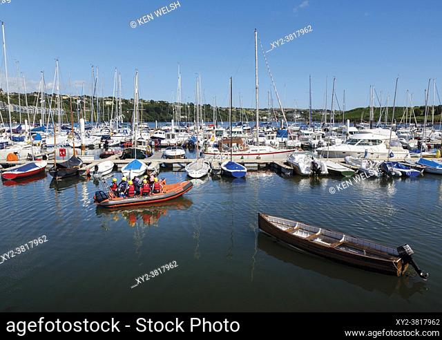 Kinsale, West Cork, County Cork, Republic of Ireland. Eire. Kinsale. The harbour. Children learning seamanship skills in inflatable dinghy