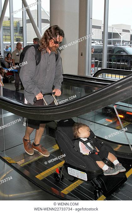 Christian Bale arrives at Los Angeles International Airport (LAX) with his son Joseph Bale Featuring: Christian Bale, Joseph Bale Where: Los Angeles, California