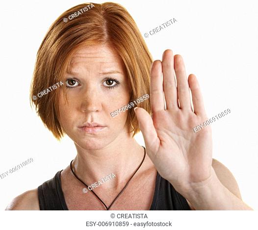 Tired young white woman with hand gesture for stop