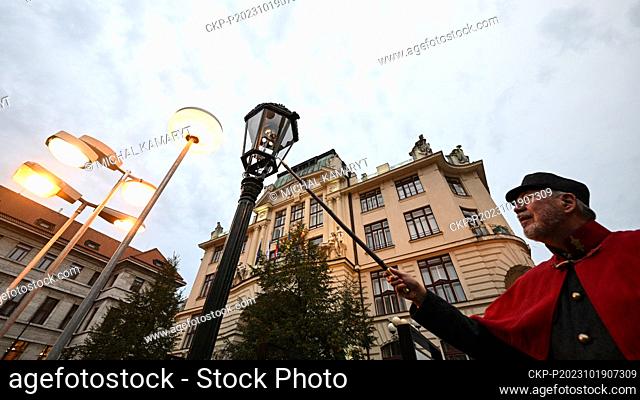 Jan Zakovec, head of the Gas Industry Museum and president of the Guild of Lamplighters, in a costume of a lamplighter, lights up a gas lamp at the opening of...