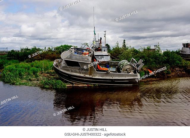 Fishing Boat Docked on Riverbank