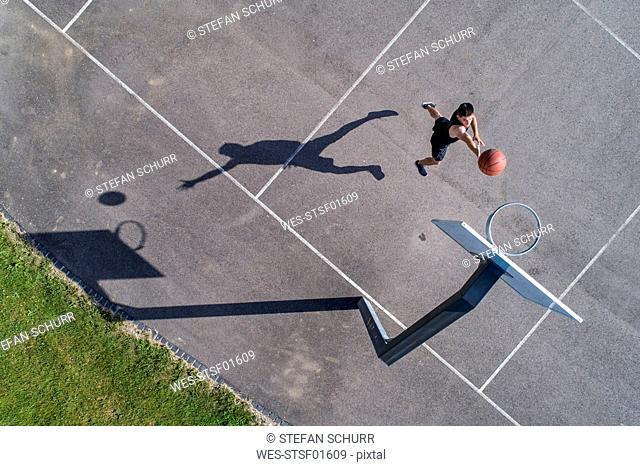 Aerial view of young man playing basketball