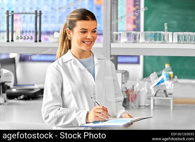 female scientist with clipboard in laboratory