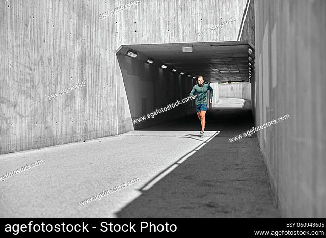 young man running out of tunnel