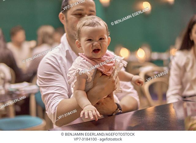father with baby at table in restaurant, Vegan Oriental, Kismet, in Munich, Germany