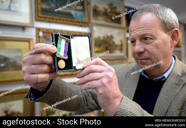 Nick Bowkett, Director/Auctioneer at Stroud Auction Rooms in Gloucestershire, with a Hallmarked silver suffragette Hunger Strike medal awarded to Frances...