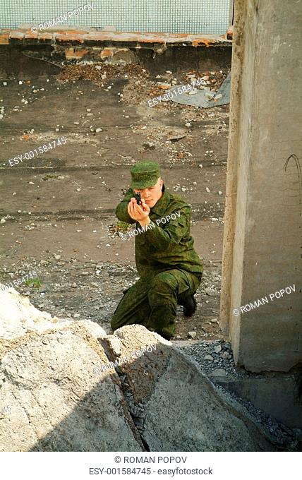 The soldier with a pistol performs antiterrorist operation