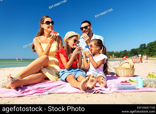 happy family having picnic on summer beach