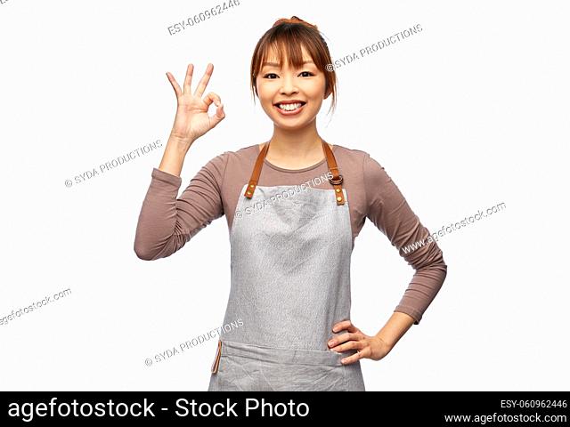 happy female chef or waitress showing ok gesture