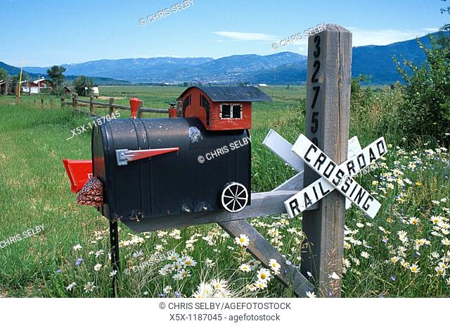 Railroad crossing sign on mailbox decorated as a train, Steamboat Springs, Colorado, USA