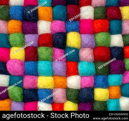 Colorful felted little balls full frame decorative background