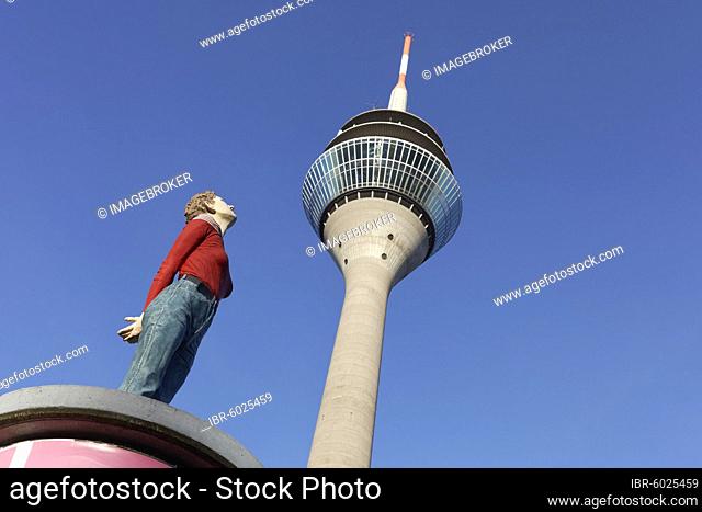 Realistic female figure on an advertising pillar in front of the Rhine Tower, column saint Marlis, sculpture by Christoph Pöggeler, Media Harbour Düsseldorf