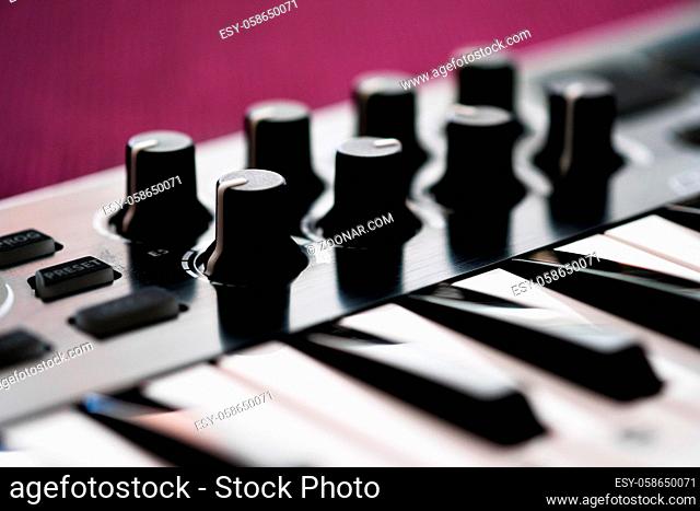 Close up image midi electronic musical keyboard, modern device, horizontal image selective focus, no people