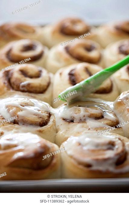 Cinnamon buns with pecan nuts and a butter glaze
