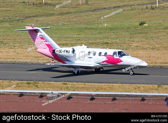 A Cessna 525 CitationJet 1 aircraft of the Pink Sparrow with registration OE-FMU at Dortmund Airport, Germany, Europe