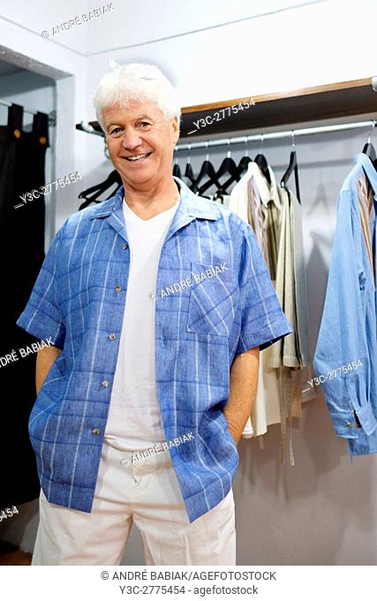 Senior man in his 60s trying new outfit in clothing store. Shopping, Puerto Vallarta, Mexico