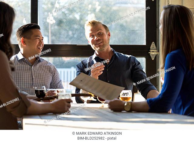 Friends talking at table in brew pub