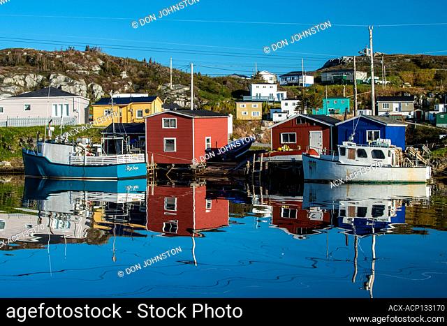 Fishing village buildings andboats reflected in the inner harbour, Rose Blanche, Newfoundland and Labrador NL, Canada