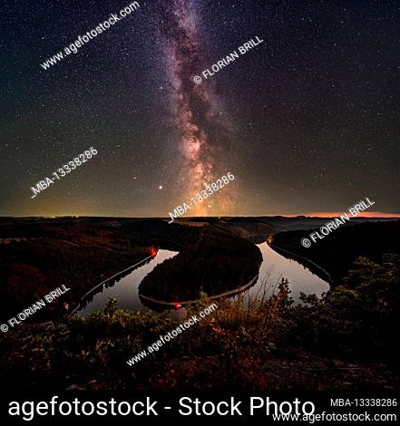 The Milky Way extends vertically over the loop of the Hohenwarte reservoir
